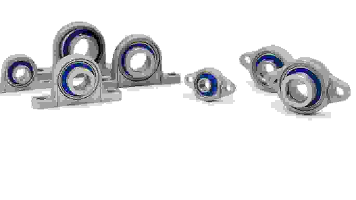  Different types and sizes of mini stainless steel bearings on white background